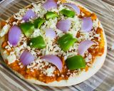 A picture of step 4 of Pizza with readymade Pizzabase.
