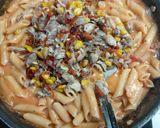 A picture of step 5 of Pink cheese pasta with garlic bread.