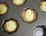 A picture of step 5 of Cookie cups filled with custard n fruits.