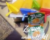 A picture of step 2 of Tang Orange Flavoured Popsicles.