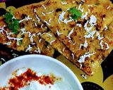 A picture of step 4 of Paneer onion paratha with melting butter.