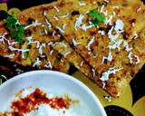 A picture of step 4 of Paneer onion paratha with melting butter.