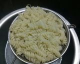 A picture of step 3 of Cheesey spiral Pasta in red sauce.