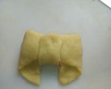 A picture of step 15 of Bow tie buns.