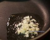 A picture of step 3 of Burnt garlic aspagauraus topped with parmesan cheese.