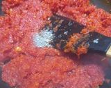 A picture of step 3 of Gajar Ka Halwa with milk and cashews.