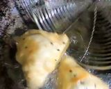 A picture of step 15 of Samosa with spicy red chutney.
