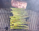 A picture of step 3 of Sticky Asian pork ribs with grilled asparagus over red wine feta aioli.