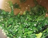A picture of step 8 of Turkey Cutlets with sautéed spinach and tomato slices.