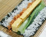 A picture of step 3 of California Roll using Grilled Salmon.