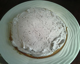 A picture of step 8 of White Butter Cake layered with Raspberry Cream with a White Chocolate Frosting.