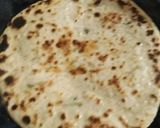 A picture of step 4 of Mooli ki parathi with achar aur butter.