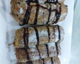 A picture of step 4 of Banana cinnamon bread rolls with chocolate syrup garnish.