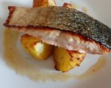 A picture of step 3 of Pan fried salmon on an open jacket with dill and butter.