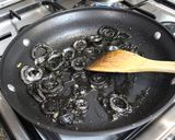 A picture of step 5 of Paella with Squid and Squid Ink.