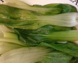 A picture of step 6 of BBQ Chicken Quinoa on a bed of pak choy.