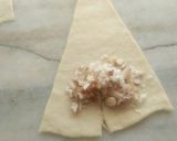 A picture of step 6 of Stuffed dry fruits coconut Croissants drizzled with chocolate sy.