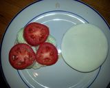 A picture of step 6 of Taisen's english muffin w/tomato, cucumber, cheese and dressing.