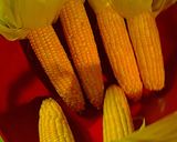 A picture of step 2 of Oven roasted corn unhusked and cauliflower.