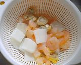 A picture of step 1 of Seafood Tomato Pasta Soup.