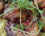 A picture of step 4 of Lemon and herb chicken on a bed of rice.