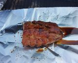 A picture of step 7 of Sticky Asian pork ribs with grilled asparagus over red wine feta aioli.
