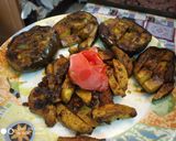A picture of step 8 of Stuff Brinjal with potato wedges.