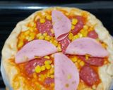 A picture of step 4 of Pizza covered with homemade Mozzarella Cheese & Sausage.
