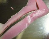 A picture of step 2 of Onigiri with a Kamaboko Rose.