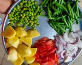 A picture of step 1 of French beans potatoes and peas curry in African style.