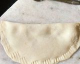 A picture of step 3 of Aloo Afghani Bolani served with cheesy yoghurt sauce.