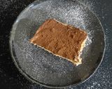 A picture of step 6 of Tiramisu with whipping cream.