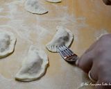 A picture of step 4 of Mini Calzones with Sausage and Cheese Filling.