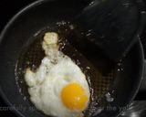 A picture of step 4 of My version of Thai Basil Beef (Pad Ka Prao) with dried chillies, topped with fried eggs.