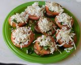 A picture of step 3 of Hummus stuffed cheesy mushrooms.
