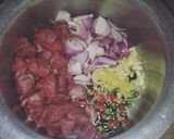 A picture of step 1 of Aalu Gosht.