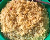 A picture of step 2 of Fried rice n plantain with chicken sauce garnished with kale leaf.