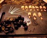 A picture of step 6 of March of the penguins, olive and cheese bites.