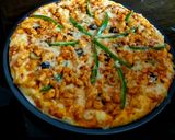 A picture of step 4 of Chicken Tikka pizza.