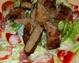 A picture of step 9 of Caesar saled with beef and a twist.