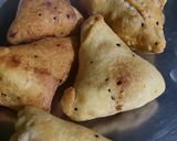 A picture of step 16 of Samosa with spicy red chutney.