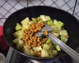 A picture of step 2 of Green papaya with black chana and potatoes.