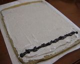 A picture of step 10 of Rich Black Sesame Roll Cake.