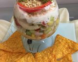 A picture of step 3 of Greek layered elbow pasta salad.