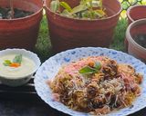 A picture of step 9 of Smokey tandoori chicken drumsticks biryani with mint mango raita.