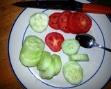 A picture of step 1 of Taisen's english muffin w/tomato, cucumber, cheese and dressing.