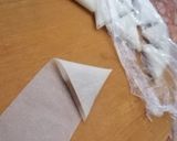A picture of step 4 of Samsa with pastry sheets stuffed with almonds.