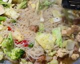 A picture of step 7 of Thai style Stir-fried rice noodles with chicken and sausages.