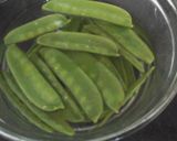 A picture of step 2 of My New Potatoes in Garlic Parsley Butter with Pea Pods 😙.