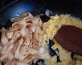 A picture of step 3 of Pad thai with king prawns and lemon slices and tagliatelle rice.